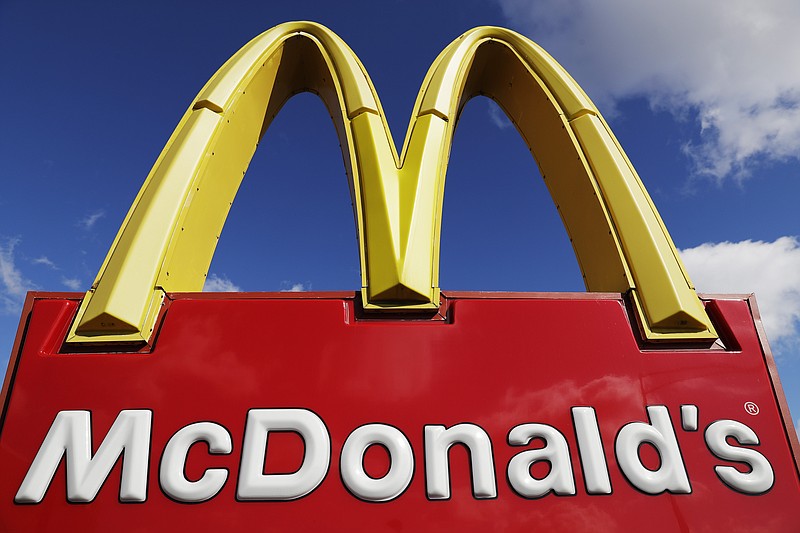 FILE - A McDonald's sign is displayed outside the fast food restaurant in Wheeling, Ill., Thursday, April 9, 2020. McDonald's says it will be requiring customers to wear face coverings when entering its U.S. restaurants as the number of new virus cases continue to surge in many states. The move, announced Friday, July 24, 2020 will be in effect on Aug. 1. (AP Photo/Nam Y. Huh)