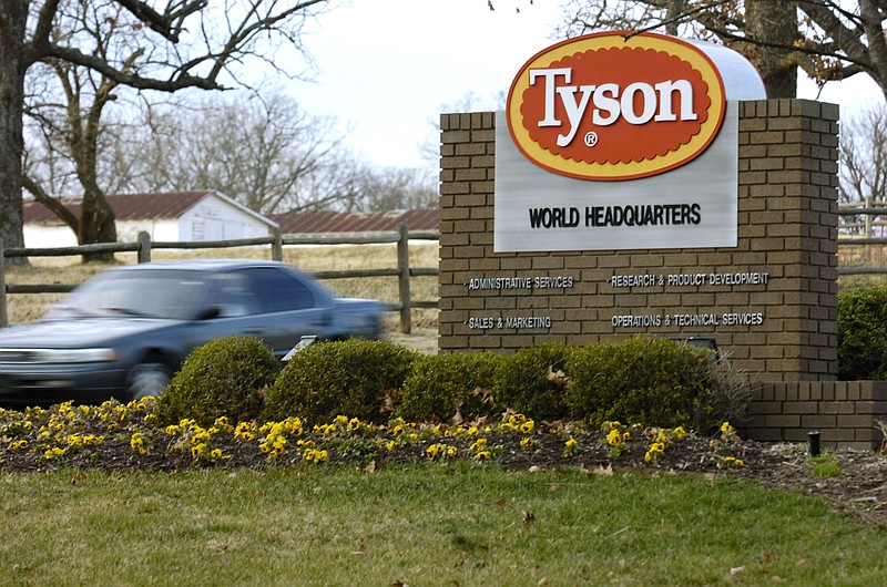 FILE - In this Jan. 29, 2006, file photo, a car passes in front of a sign at Tyson headquarters in Springdale, Ark. (AP Photo/April L. Brown, File)