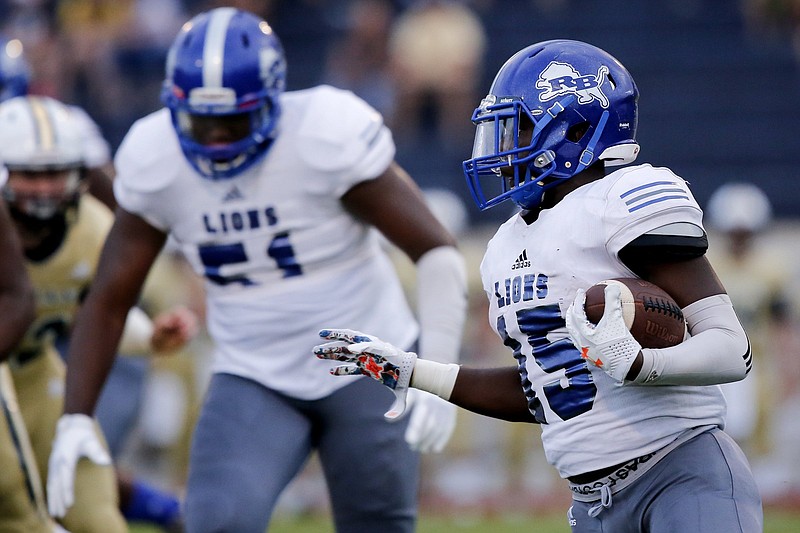 Staff file photo by C.B. Schmelter/ Red Bank's Lumiere Strickland (15) has become a star running back and 1,000-yard rusher the past two seasons with the help of offensive lineman BJ Ragland (51). Ragland committed to Tulane on Wednesday.