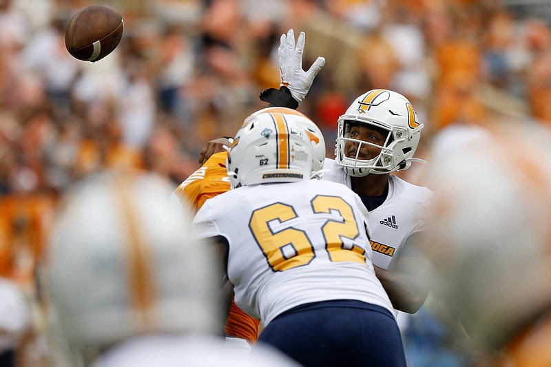 Staff photo by C.B. Schmelter / UTC quarterback Drayton Arnold passes under pressure during the Mocs' game against Tennessee on Sept. 14, 2019.