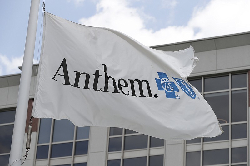 FILE - In this May 14, 2019, file photo a flag flies the outside of the corporate headquarters building of health insurance company Anthem is shown in Indianapolis.