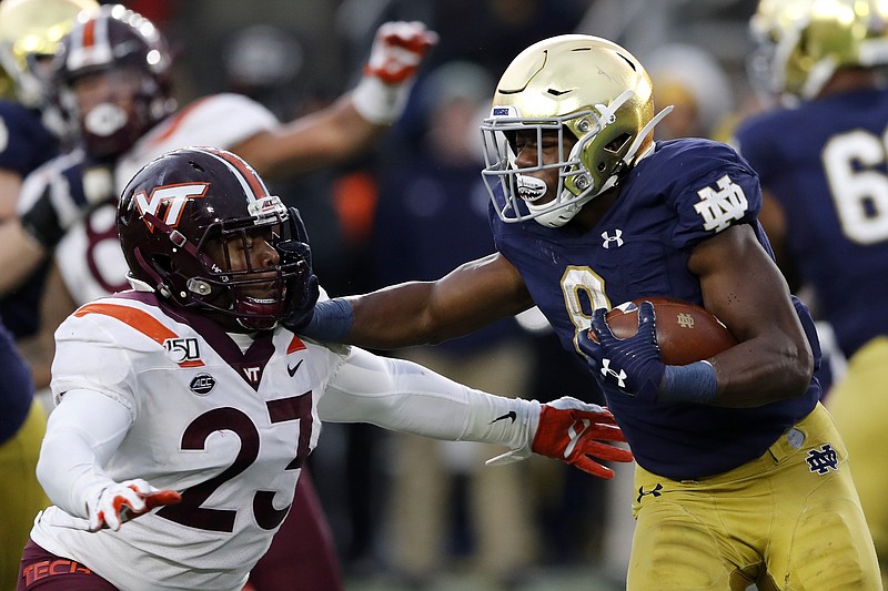 AP photo by Carlos Osorio / Notre Dame running back Jafar Armstrong stiff-arms Virginia Tech linebacker Rayshard Ashby on Nov. 2, 2019, in South Bend, Ind.