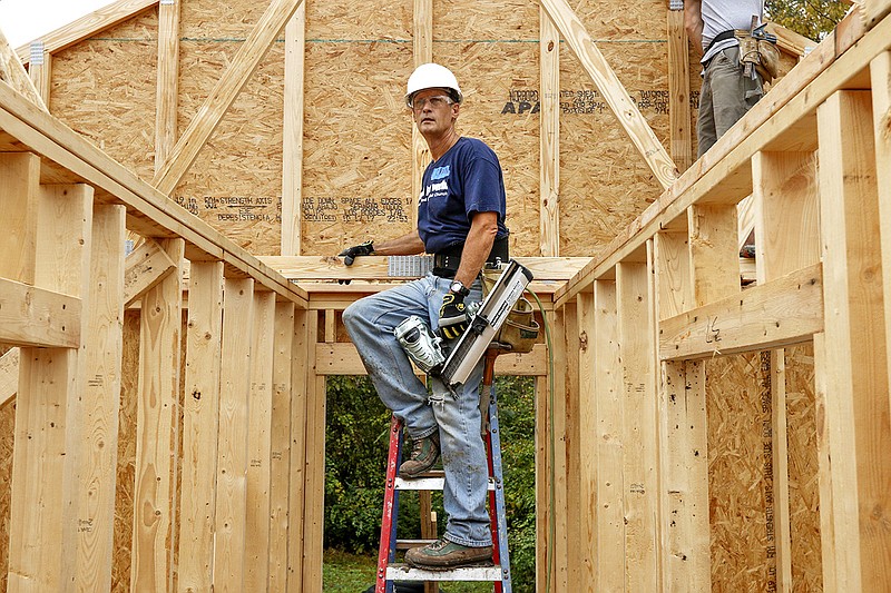 Staff file photo / Craig Schand holds a nail gun during a 2017 Habitat for Humanity home build in Chattanooga.