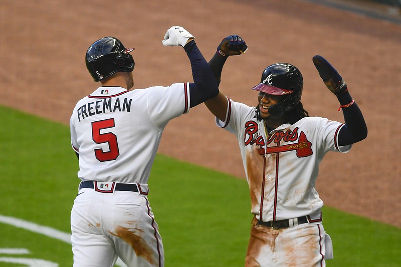 AP photo by John Amis / Atlanta Braves first baseman Freddie Freeman celebrates his two-run homer with outfielder Ronald Acuña Jr. during the third inning of Wednesday's home opener against the Tampa Bay Rays.