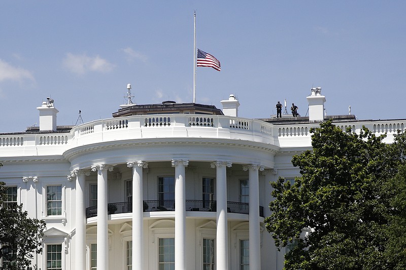 In this July 18, 2020, file photo, a U.S. flag flies at half-staff over the White House in Washington in remembrance of Rep. John Lewis, D-Ga. President Donald Trump did not pay his respects when Lewis lay in state in the Capitol Rotunda. Iwas another break in convention for a president who has broken so many norms, and one that underscored his separation from much of Washington society, along with his dismal relationship with Democrats on Capitol Hill — especially members of color. (AP Photo/Patrick Semansky, File)