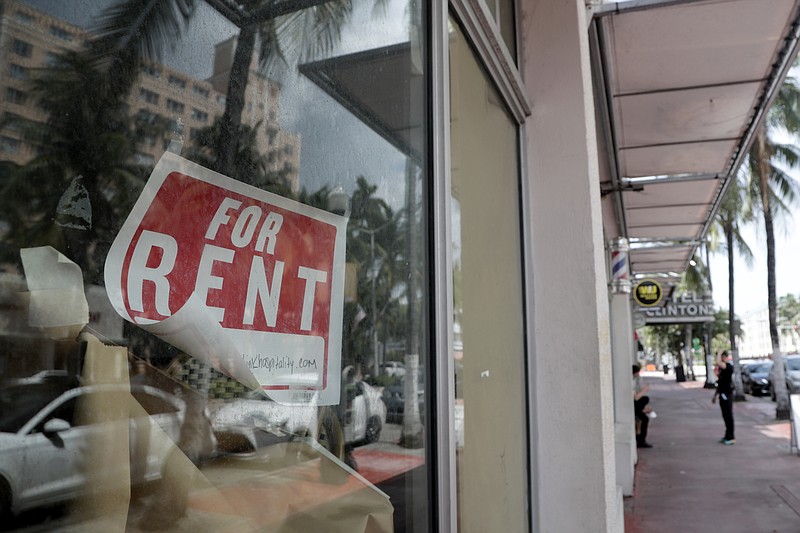 In this July 13, 2020 file photo, a For Rent sign hangs on a closed shop during the coronavirus pandemic in Miami Beach, Fla. Having endured what was surely a record-shattering slump last quarter, the U.S. economy faces a dim outlook as a resurgent coronavirus intensifies doubts about the likelihood of any sustained recovery the rest of the year. (AP Photo/Lynne Sladky)