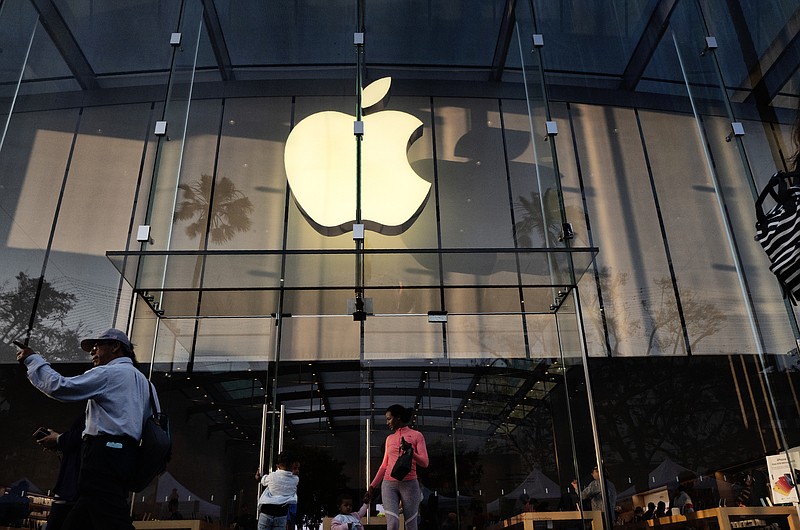 FILE - In this June 15, 2019, file photo customers leave an Apple store on the 3rd Street Promenade in Santa Monica, Calif. Big Tech companies reported mixed quarterly earnings on Thursday, July 30, 2020, a day after their top executives faced a tough congressional grilling over their market power and alleged monopolistic practices. (AP Photo/Richard Vogel, File)


