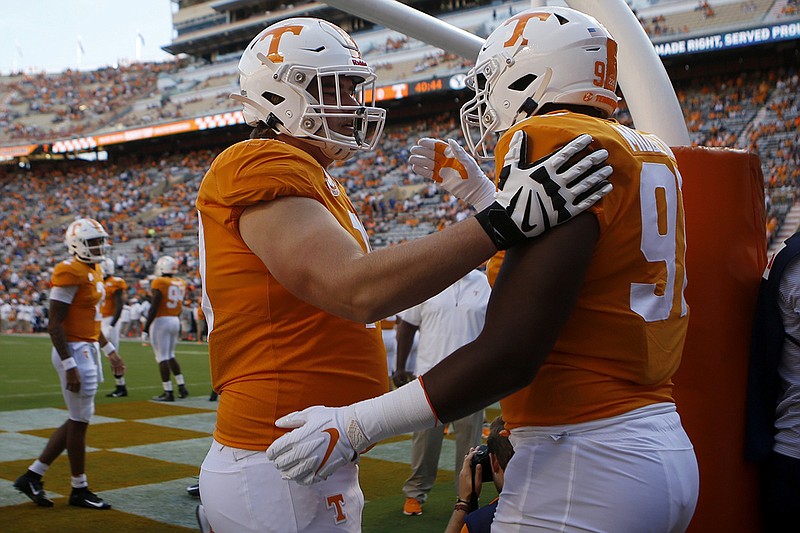 Staff photo by C.B. Schmelter / Tennessee offensive lineman Ryan Johnson, left, greets defensive lineman Darel Middleton as they take the field to warm up before a home game against BYU on Sept. 7, 2019.