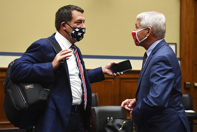 Rep. Mark Green, R-Tenn., talks to Dr. Anthony Fauci, director of the National Institute for Allergy and Infectious Diseases, before a House Subcommittee hearing on the Coronavirus crisis, Friday, July 31, 2020 on Capitol Hill in Washington. (Kevin Dietsch/Pool via AP)