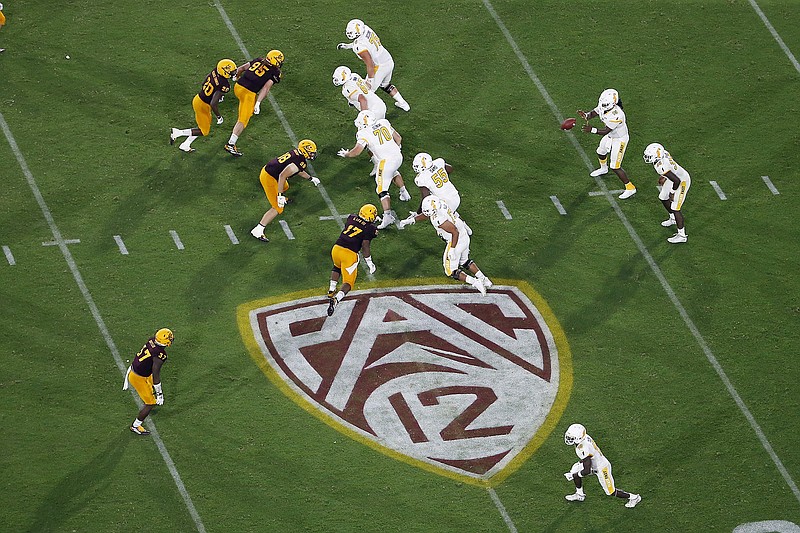 AP photo by Ralph Freso / Pac-12 program Arizona State's defense, left, moves after the snap by Kent State during a nonconference matchup on Aug. 29, 2019, in Tempe, Ariz.