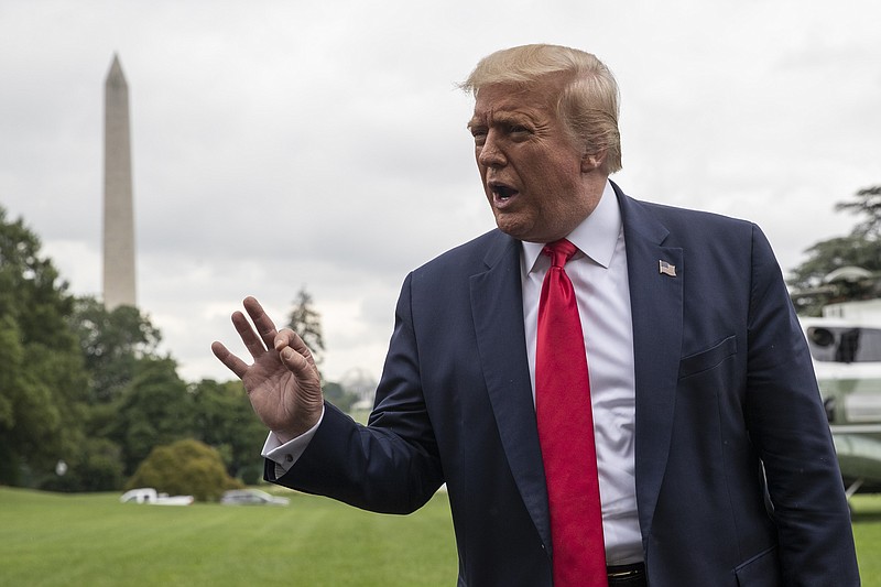President Donald Trump speaks with reporters as he walks to Marine One on the South Lawn of the White House, Friday, July 31, 2020, in Washington. Trump is en route to Florida. (AP Photo/Alex Brandon)