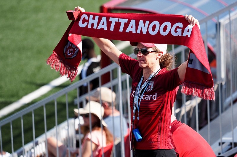 Staff photo by C.B. Schmelter / A Chattanooga Red Wolves SC supporter holds up a scarf at the beginning of the second half of a USL League One match against FC Tucson at CHI Memorial Stadium on Saturday in East Ridge.