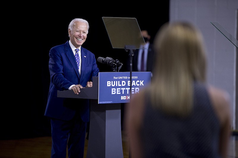 Democratic presidential candidate former Vice President Joe Biden smiles as he takes a question from a reporter at a campaign event at the William "Hicks" Anderson Community Center in Wilmington, Del., Tuesday, July 28, 2020.(AP Photo/Andrew Harnik)