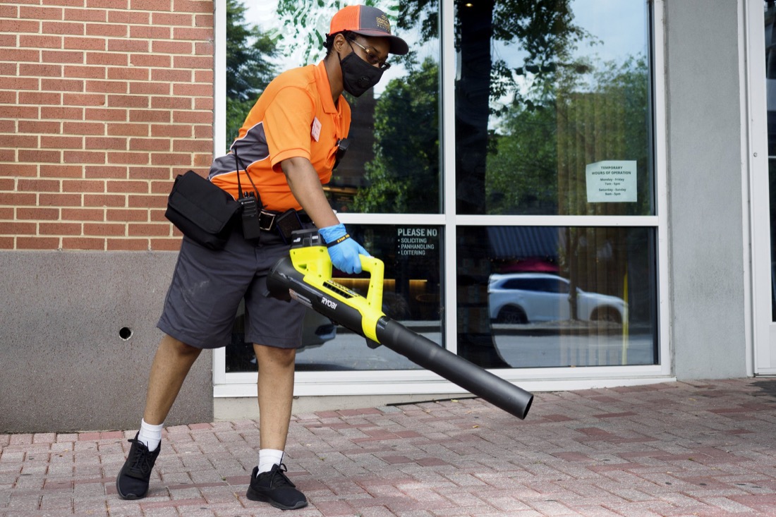 Staff photo by C.B. Schmelter / Downtown Chattanooga Alliance Team Leader Katrina Mason cleans off the sidewalk along Broad Street on Saturday, Aug. 1, 2020 in Chattanooga, Tenn.