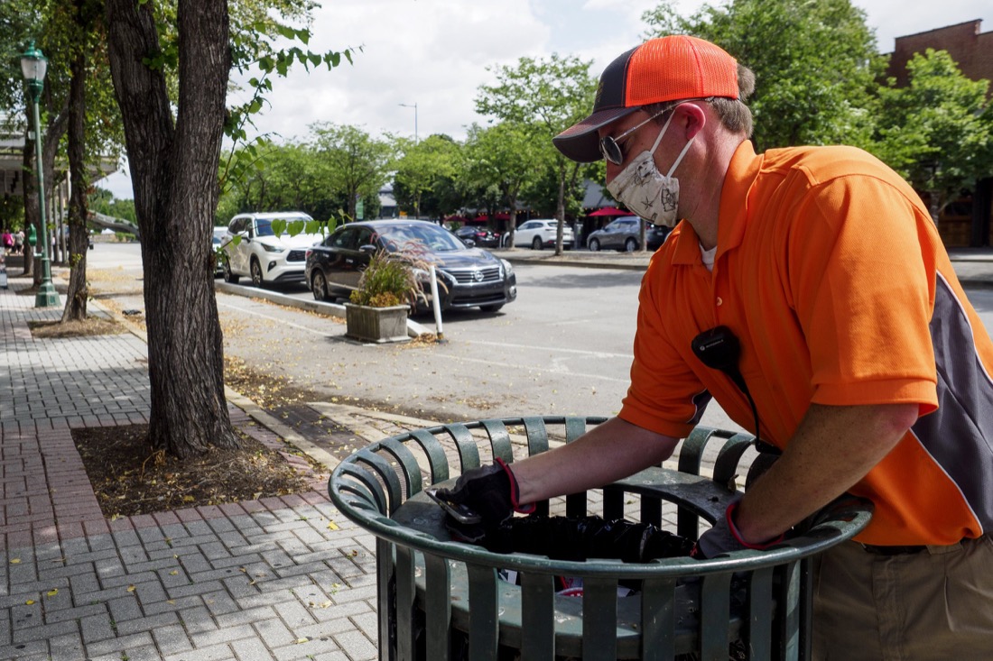 Staff photo by C.B. Schmelter / Downtown Chattanooga Alliance Director Steve Brookes cleans a trash can along Broad Street on Saturday, Aug. 1, 2020 in Chattanooga, Tenn.
