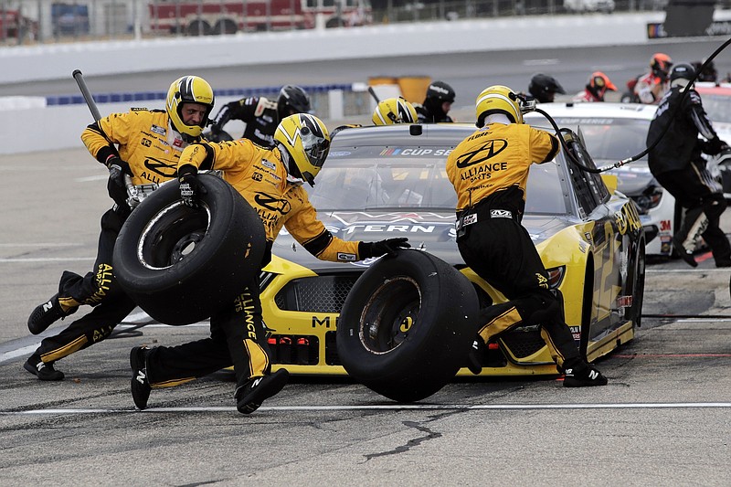 AP photo by Charles Krupa / NASCAR driver Brad Keselowski's crew scrambles during a pit stop in Sunday's Cup Series race at New Hampshire Motor Speedway.