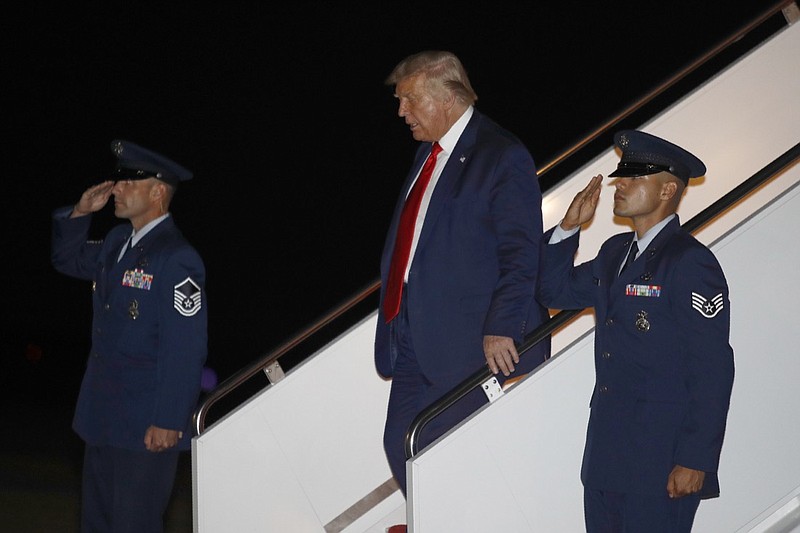 President Donald Trump steps off Air Force One at Andrews Air Force Base, Md., Friday, July 31, 2020. Trump is returning to Washington after attending events in Florida. (AP Photo/Patrick Semansky)