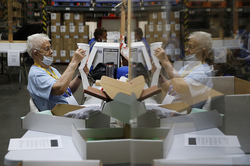 In this June 9, 2020, file photo, election workers process mail-in ballots during a nearly all-mail primary election in Las Vegas. (AP Photo/John Locher, File)