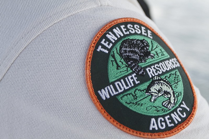 Staff file photo / A Tennessee Wildlife Resources Agency patch on the shoulder of Officer Jarod Coxey in this 2010 staff file photo.