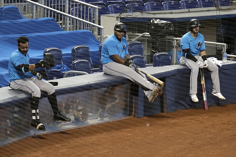 AP photo by Lynne Sladky / From left, the Miami Marlins' Jonathan Villar, Jesus Aguilar and Jon Berti wait to bat during a July 12 scrimmage at Marlins Park.