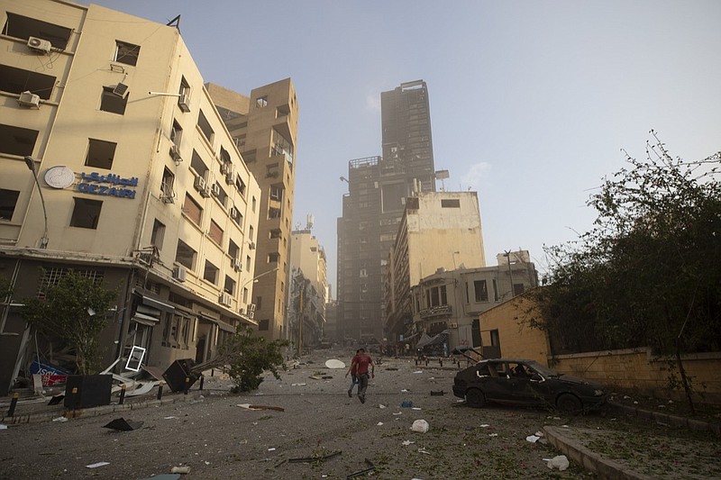 Aftermath of a massive explosion is seen in in Beirut, Lebanon, Tuesday, Aug. 4, 2020. Massive explosions rocked downtown Beirut on Tuesday, flattening much of the port, damaging buildings and blowing out windows and doors as a giant mushroom cloud rose above the capital. Witnesses saw many people injured by flying glass and debris. (AP Photo/Hassan Ammar)
