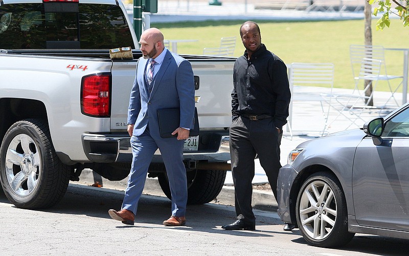 Staff photo by Erin O. Smith / Attorney Sam Byrd and his client former Chattanooga police officer Desmond Logan walk across Georgia Avenue before entering the Joel W. Solomon Federal Building and U.S. Courthouse Thursday, September 12, 2019 in Chattanooga, Tennessee. Logan reached a plea agreement last week, in which he admitted to raping three women in his custody between 2015 and 2018 as well as shooting a Taser at a fourth woman.