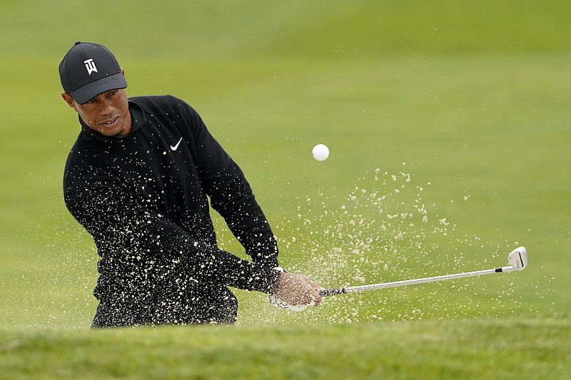 AP photo by Charlie Riedel / Tiger Woods hits from the bunker on the 17th hole at San Francisco's TPC Harding Park during a practice round Wednesday for the PGA Championship.
