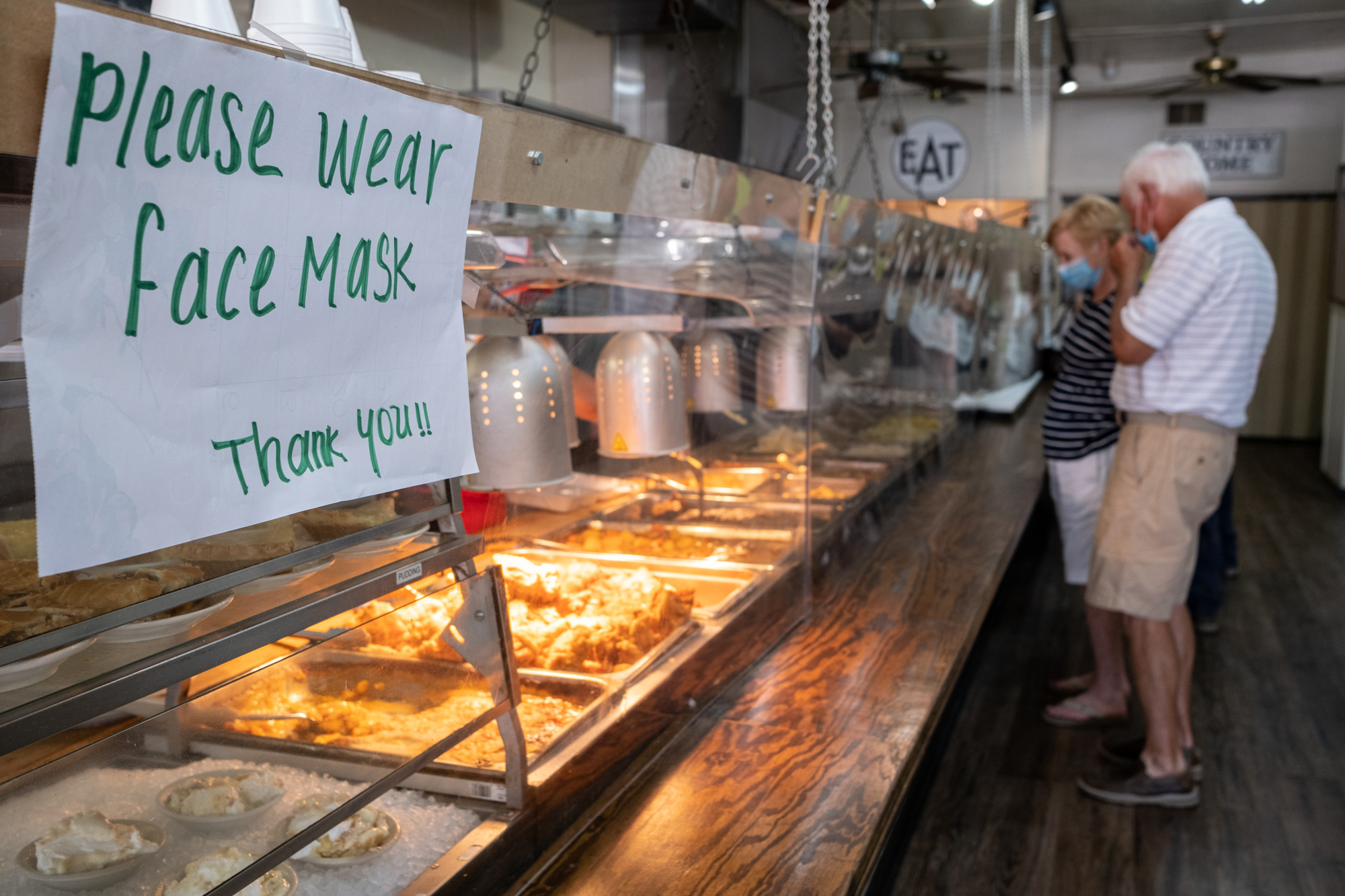 200717-Tucker-Sheets of acrylic separate the food from the hungry lunch crowd at Matthews Cafeteria on Main Street in Tucker on Friday afternoon July 17, 2020. The dining institution, established in 1955, ask customers to wear masks, added the acrylic dividers, made separate entrance and exit doors and have drive-up service. Ben Gray for the Atlanta Journal-Constitution.