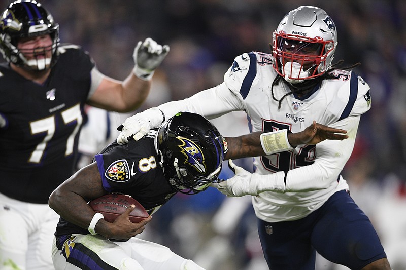 AP photo by Nick Wass / New England Patriots outside linebacker Dont'a Hightower, right, tackles Baltimore Ravens quarterback Lamar Jackson on Nov. 3, 2019, in Baltimore. Hightower is one of eight Patriots who has opted out of the 2020 NFL season due to coronavirus concerns.