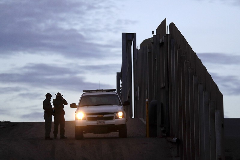 In this Nov. 21, 2018 file photo, United States Border Patrol agents stand by a vehicle near one of the border walls separating Tijuana, Mexico and San Diego, in San Diego. As of this week, the ACLU has filed nearly 400 lawsuits and other legal actions against the Trump administration, some meeting with setbacks but many resulting in important victories. Of the lawsuits, 174 have dealt with immigrant rights, targeting the family separation policy, detention and deportation practices, and the administration's repeated attempts to make it harder to seek asylum at the U.S.-Mexico border. (AP Photo/Gregory Bull, File)