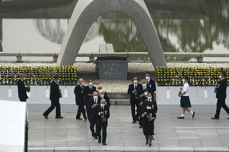 Participants gather at Hiroshima Memorial Cenotaph during the ceremony to mark the 75th anniversary of the bombing at the Hiroshima Peace Memorial Park in Hiroshima, western Japan Thursday, Aug. 6, 2020. (AP Photo/Eugene Hoshiko)