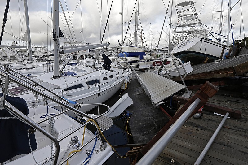 Boats are piled on each other in the marina following the effects of Hurricane Isaias in Southport, N.C., Tuesday, Aug. 4, 2020. Hurricane season has already been busy this year, but forecasters say it should get even nastier soon. The National Oceanic and Atmospheric Administration Thursday, Aug. 6 increased its forecast for the number of named storms, hurricanes and major hurricanes this year to far above normal. (AP Photo/Gerry Broome, File)