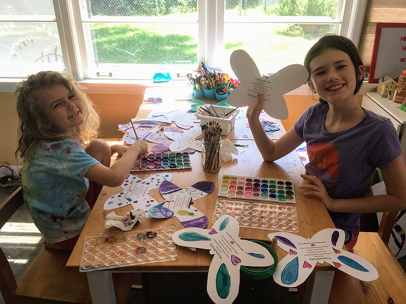 Avery (left) and Phoebe (right) Gilligan painting some of the butterfly door-hangers that they donated to Morning Pointe of East Hamilton. / Contributed photo