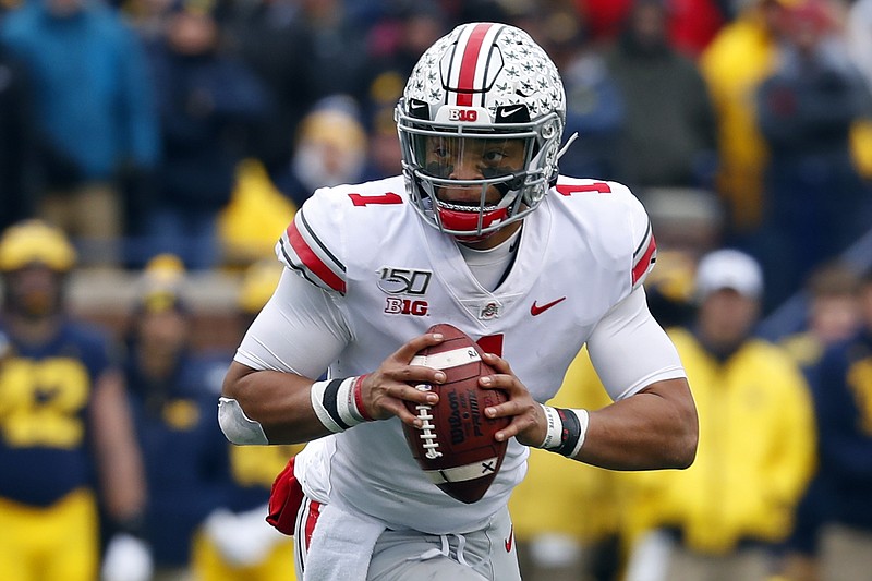 AP file photo by Paul Sancya / Ohio State quarterback Justin Fields