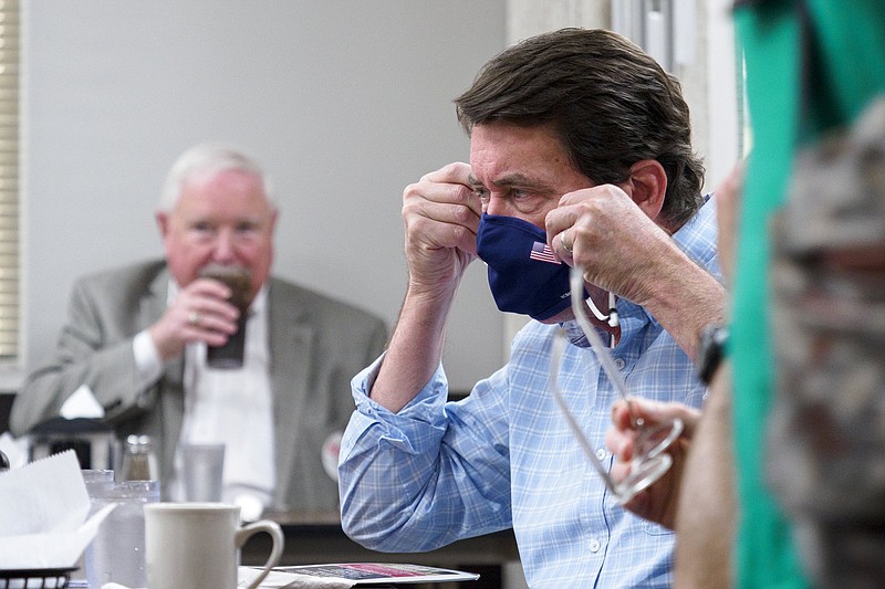 Staff Photo By C.B. Schmelter / Republican Party Senate primary winner Bill Hagerty puts on his mask to speak to supporters on Election Day Thursday at Wally's restaurant in Chattanooga.