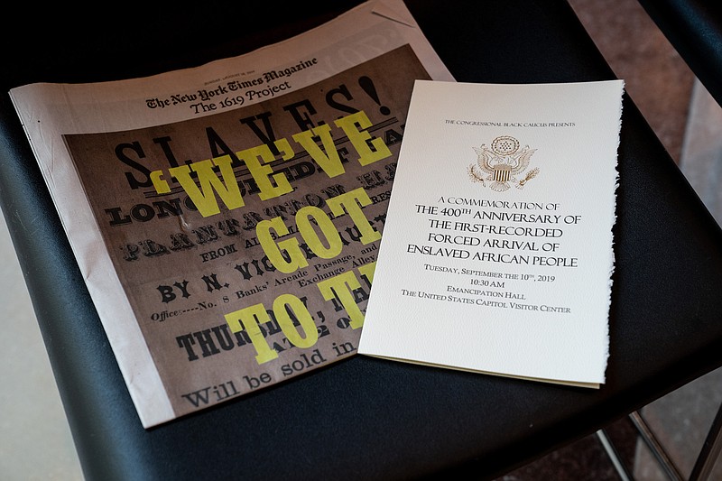 Photo by Erin Schaff of The New York Times / A copy of The New York Times Magazine's 1619 Project and a program are placed on a chair at a ceremony to commemorate the 400th anniversary of the first-recorded forced arrival of enslaved African people to the United States on Capitol Hill in Washington on Sept. 10, 2019.