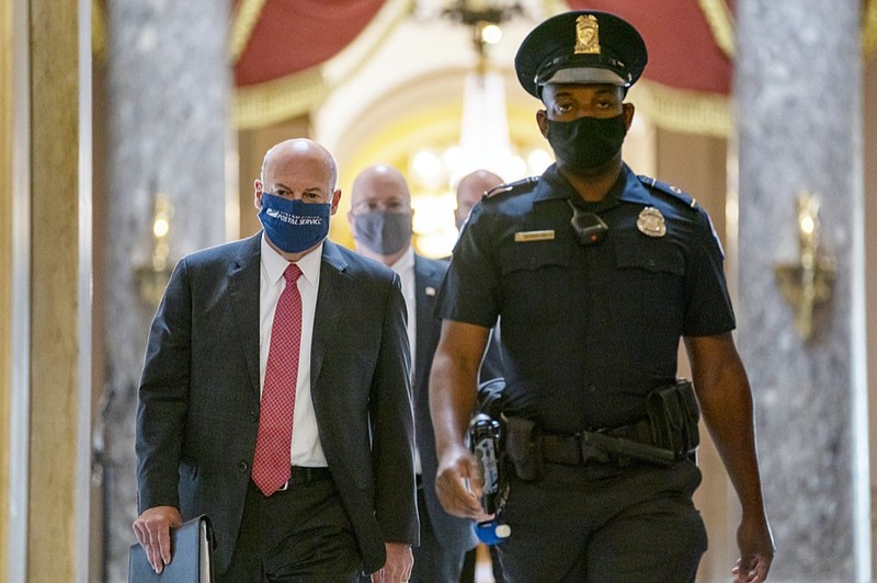 Postmaster General Louis DeJoy, left, is escorted to House Speaker Nancy Pelosi's office on Capitol Hill in Washington, Wednesday, Aug. 5, 2020. Some clarity is beginning to emerge from the bipartisan Washington talks on a huge COVID-19 response bill. An exchange of offers and meeting devoted to the Postal Service on Wednesday indicates the White House is moving slightly in House Speaker Nancy Pelosi's direction on issues like aid to states and local governments and unemployment insurance benefits. But the negotiations have a long ways to go. (AP Photo/Carolyn Kaster)


