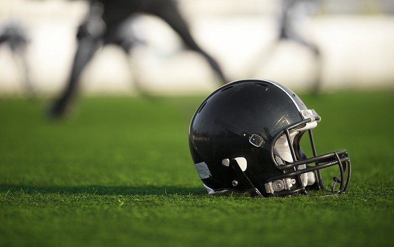 football helmet on a field tile / Getty Images