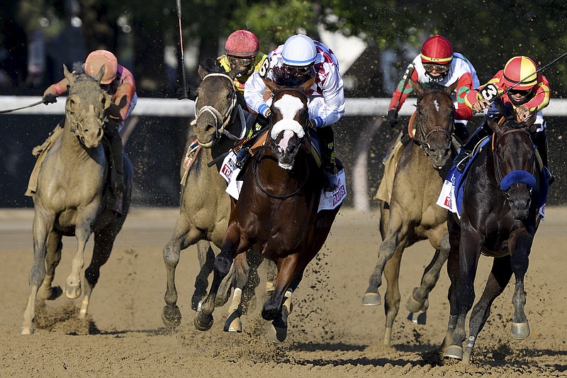 New York Racing Association photo by Elsa Lorieul via AP / Manny Franco rides Tiz the Law, center, as he leads the pack around the final turn on his way to victory in the Travers Stakes on Saturday at Saratoga Race Course in Saratoga Springs, N.Y.