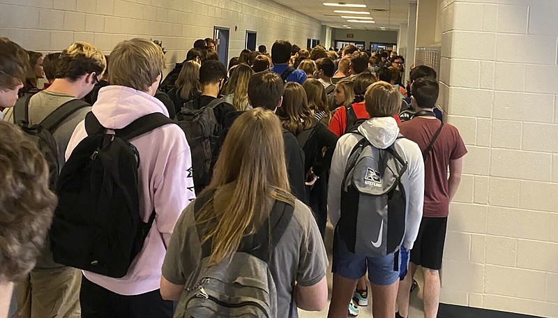 FILE - In this photo posted on Twitter, students crowd a hallway, Tuesday, Aug. 4, 2020, at North Paulding High School in Dallas, Ga. The Georgia high school student says she has been suspended for five days because of photos of crowded conditions that she provided to The Associated Press and other news organizations. Hannah Watters, a 15-year-old sophomore at North Paulding High School, says she and her family view the suspension as overly harsh and are appealing it. (Twitter via AP, File)