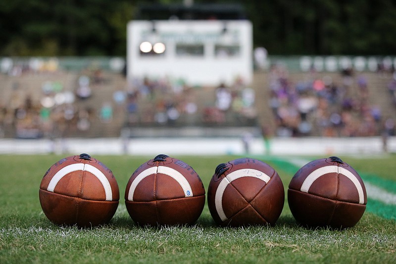 Staff photo / Footballs sit at the 50-yard line before Central's game at Notre Dame on Aug. 23, 2019.