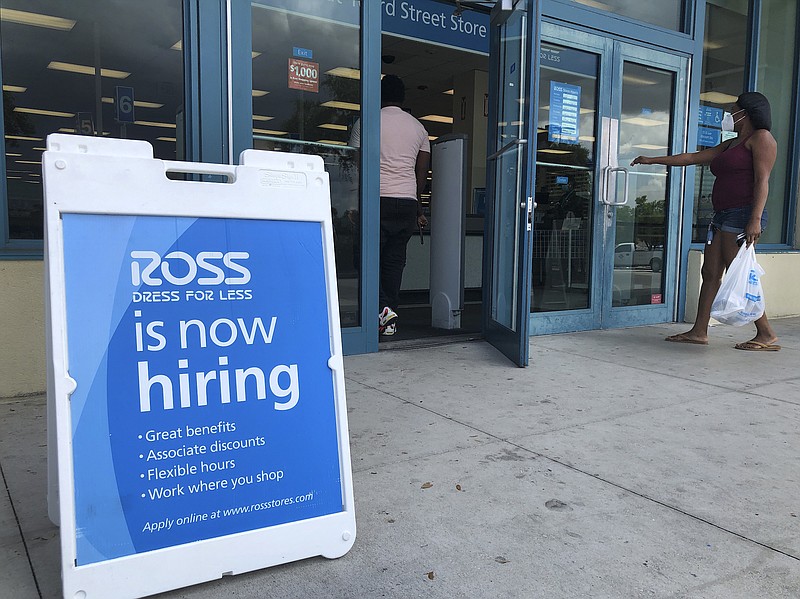 Photo by Wilfredo Lee of The Associated Press / In this July 8, 2020, file photo, a "Now Hiring" sign sits outside a Ross Dress for Less store, in North Miami Beach, Florida. The United States added 1.8 million jobs in July, a pullback from the gains of May and June and evidence that the resurgent coronavirus has weakened hiring and the economic rebound.