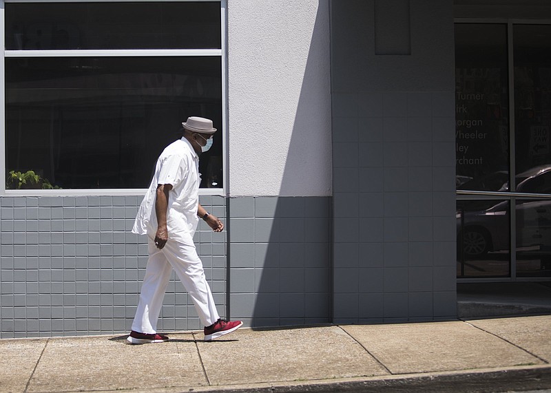 Staff photo by Troy Stolt / James Iverson Williams wears a mask as he walks up E 7th Street on Friday, Aug. 7, 2020 in Chattanooga, Tenn.
