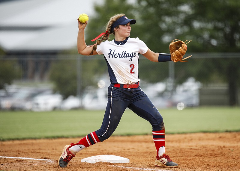 Staff photo by Troy Stolt / Heritage's Bailey Christol throws to first base during Monday's game against visiting Ringgold.