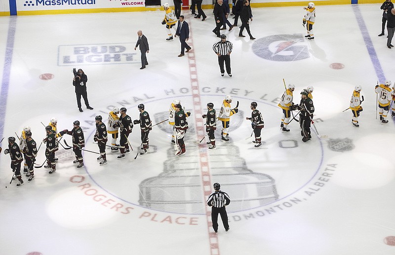 AP photo by Jason Franson / The Nashville Predators and the Arizona Coyotes shake hands after the Coyotes beat the Predators 4-3 in overtime on Friday in Edmonton to close out the best-of-five qualifying series 3-1.