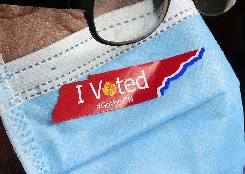 Staff Photo Illustration by Robin Rudd / In this photo illustration a man wears a protective mask with "I Voted Tennessee" sticker.
