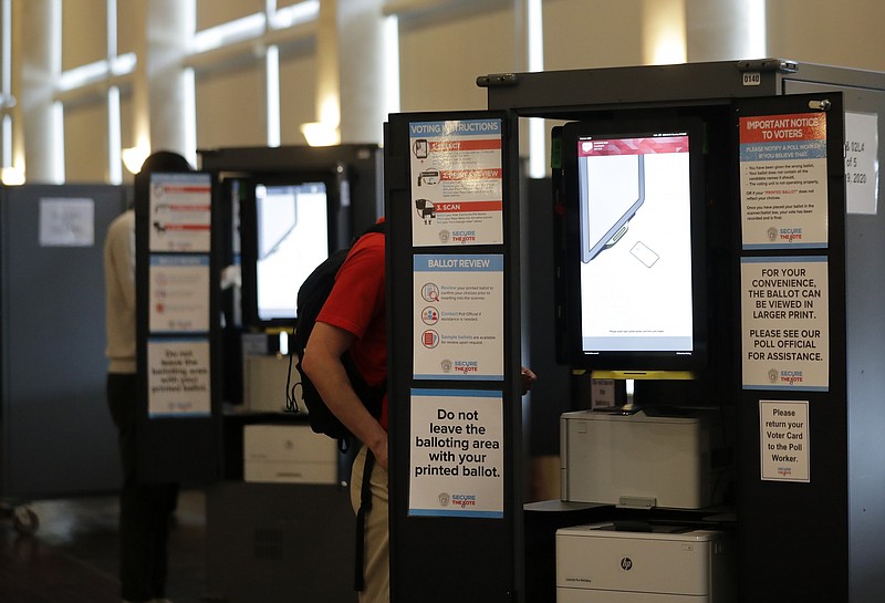 People vote at voting booths in the Georgia's primary election at Park Tavern on Tuesday, June 9, 2020, in Atlanta. (AP Photo/Brynn Anderson)