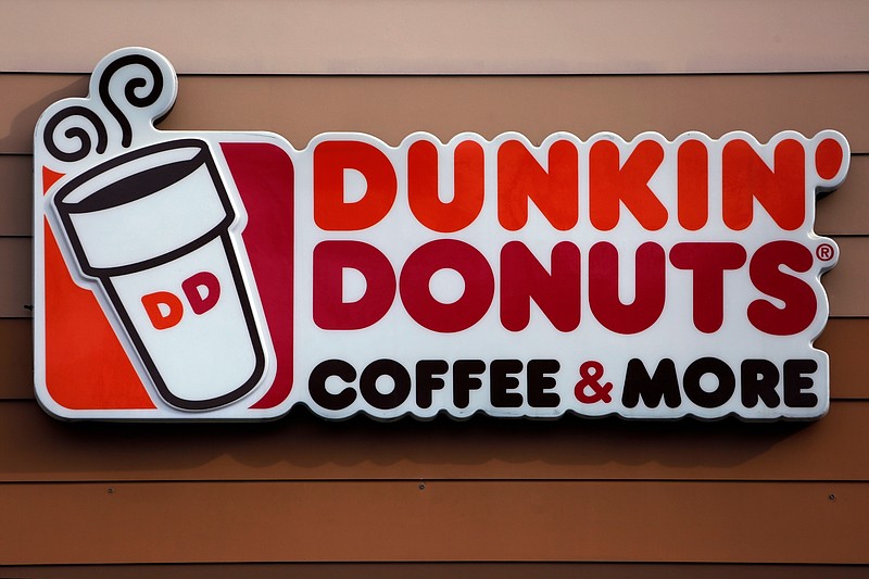 FILE - This Jan. 22, 2018, file photo shows a Dunkin' Donuts logo on a shop in Mount Lebanon, Pa. The Massachusetts-based coffee and donuts empire is teaming with Post Consumer Brands to release two new breakfast cereals based on two of its most popular coffee drinks: Caramel Macchiato and Mocha Latte. The new cereals are expected to hit grocery shelves in late August 2020. (AP Photo/Gene J. Puskar, File)