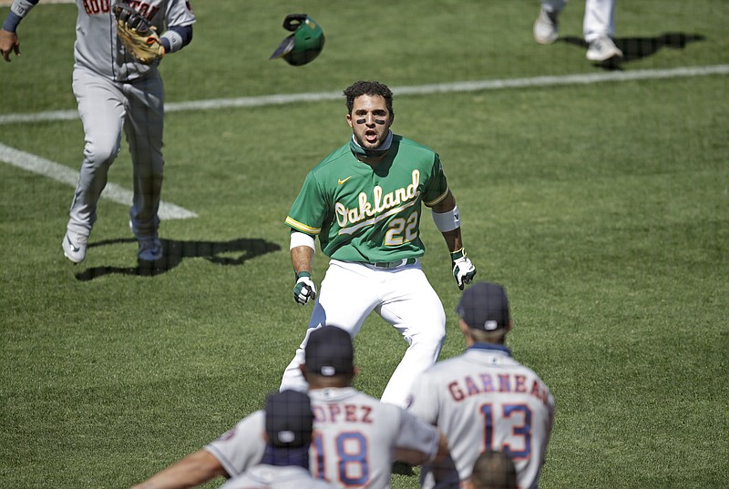 AP photo by Ben Margot / The Oakland Athletics' Ramon Laureano, center, charges the Houston Astros' dugout after being hit by a pitch thrown by Humberto Castellanos in the seventh inning of Sunday's game in Oakland, Calif.