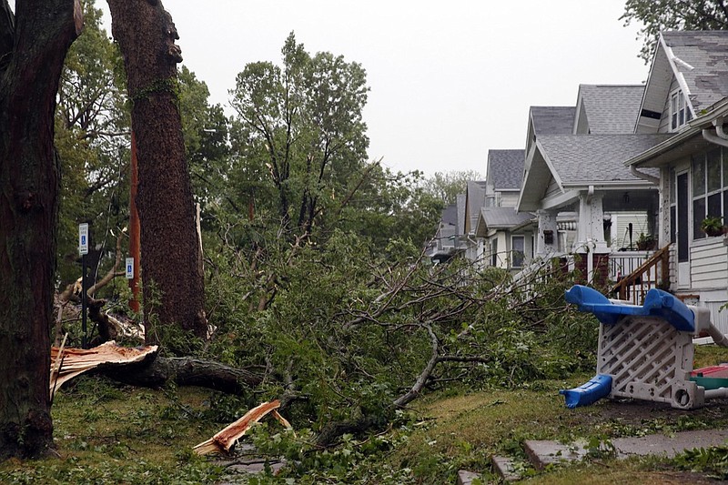 Downed trees and other debris cover front yards in Cedar Rapids, Iowa, after a powerful storm moved through Iowa on Monday, Aug. 10, 2020. (Liz Martin/The Gazette via AP)